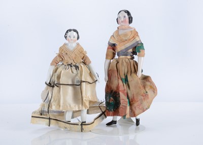 Lot 181 - Two 19th century German china shoulder-head dolls’ house dolls