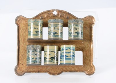 Lot 217 - An early 20th century German lithographed tinplate spice shelf with canisters