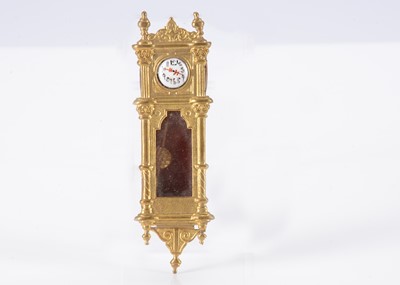 Lot 235 - A late 19th century German gilt metal dolls’ house wall clock