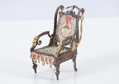 Lot 239 - A late 19th century German soft metal dolls’ house Empire style armchair