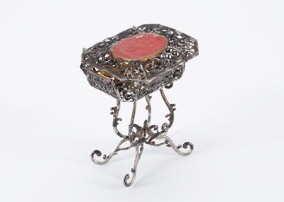 Lot 240 - A late 19th century German soft metal dolls’ house work basket on stand