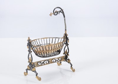 Lot 241 - A late 19th century German soft metal dolls’ house cradle