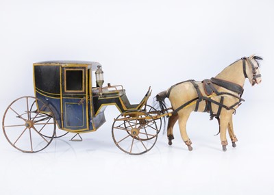 Lot 259 - A late 19th or early 20th century French tinplate horse-drawn closed coupe