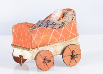 Lot 276 - A mid 19th century German composition and card baby in carriage