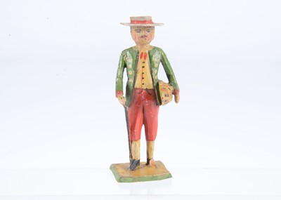 Lot 301 - A late 19th century Oberammergau carved wooden gentleman carrying a loaf of bread