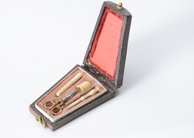 Lot 327 - An 19th century tooled leather miniature dolls’ nécessaire