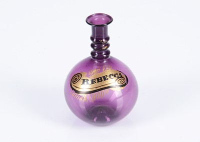 Lot 334 - A small 19th century amethyst glass bottle with gilt ‘Rebecca’ on side