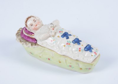 Lot 335 - An 19th century German porcelain swaddled baby trinket box