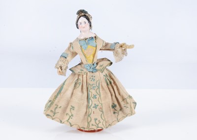 Lot 375 - An unusual 19th century German pink tinted china shoulder head dolls’ house doll