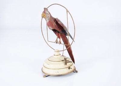 Lot 398 - An early 20th century German painted tinplate clockwork parrot on perch