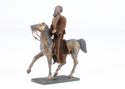 Lot 401 - An early 19th century German carved wooden mounted Hussar, possibly Oberammergau