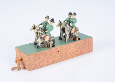 Lot 414 - An early 20th century Erzgebirge cavalry wooden crank toy