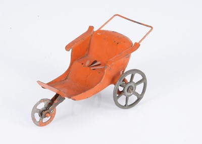 Lot 446 - An 19th century German painted tinplate dolls’ house three-wheeled push chair
