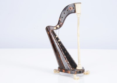 Lot 450 - A late 19th century or early 20th century bone and tortoiseshell miniature harp