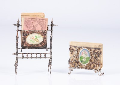 Lot 464 - An 19th century German soft metal dolls’ house newspaper and sheet music rack