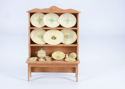 Lot 480 - An 19th century dolls’ house pine dresser with fine German painted wooden dinner service