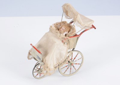 Lot 481 - An early 20th century German tinplate dolls’ house push chair