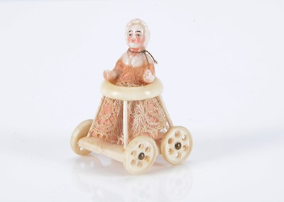Lot 497 - A rare  19th century pink tinted dolls’ house Frozen Charlotte with moulded bonnet