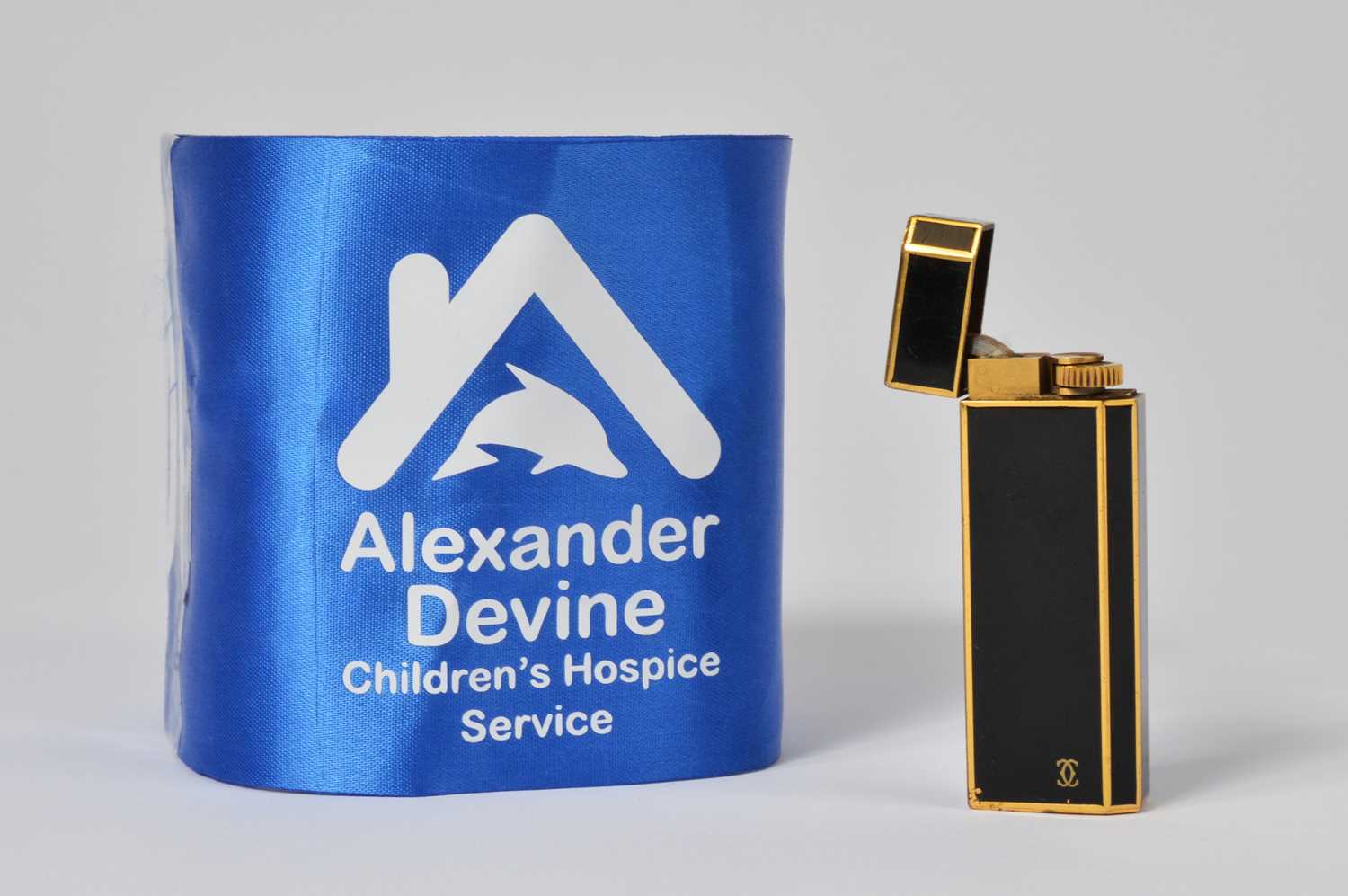 Lot 3 - A gold plated and black enamel Cartier lighter