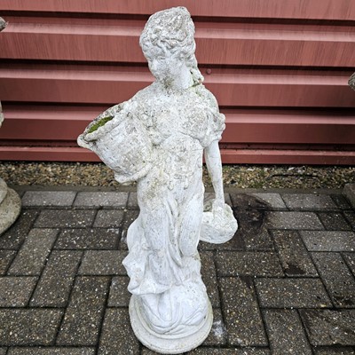 Lot 133 - A reconstituted weathered stone figure of a women holding a basket