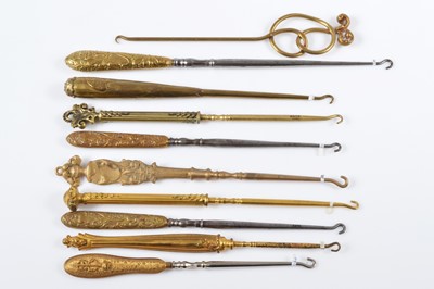 Lot 518 - A collection of late 19th and early 20th Century brass and gilt metal button hooks