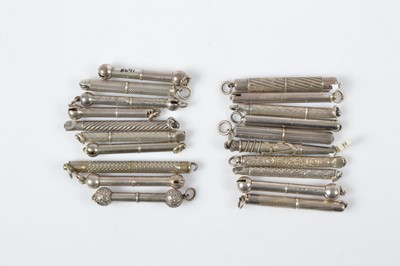 Lot 528 - A collection of silver and white metal retractable button or glove hooks