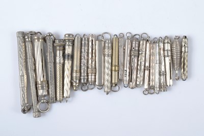 Lot 529 - A collection of silver and white metal retractable button or glove hooks