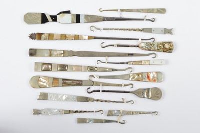 Lot 532 - A collection of mother of pearl and abalone banded and handled button hooks