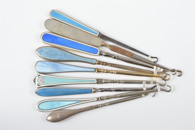 Lot 533 - A collection of nine blue guilloche enamel handled button hooks