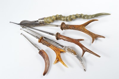 Lot 548 - Five large and impressive horn and bone handled steel button hooks