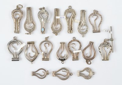 Lot 549 - Seventeen small hinged folding button or glove hooks
