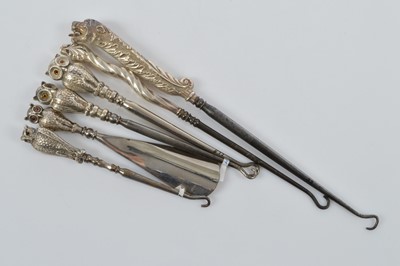 Lot 553 - Six novelty silver handled button hooks and shoe horn