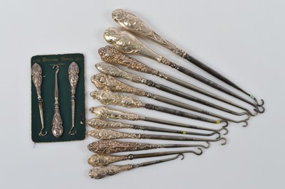 Lot 557 - A collection of silver handled steel button hooks