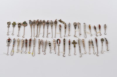 Lot 560 - A collection of small silver button or glove hooks