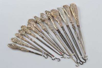 Lot 562 - A collection of silver handled steel button hooks
