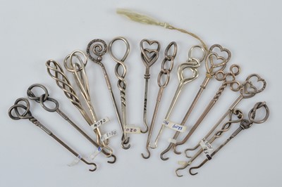 Lot 565 - A collection of silver handled small button or glove hooks