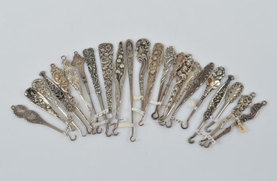 Lot 566 - A collection of flattened silver small button or glove hooks