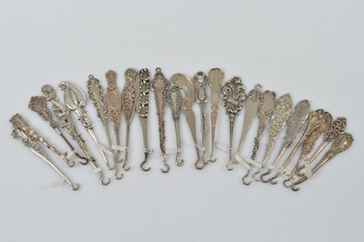 Lot 567 - A collection of flattened silver small button or glove hooks