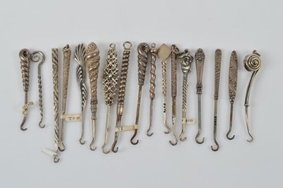Lot 569 - A collection of small silver button or glove hooks
