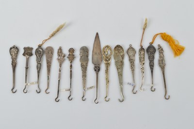 Lot 570 - A collection of small silver button or glove hooks