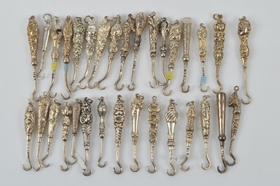 Lot 581 - A collection of small silver button or glove hooks