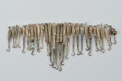 Lot 584 - A collection of small silver handled button or glove hooks
