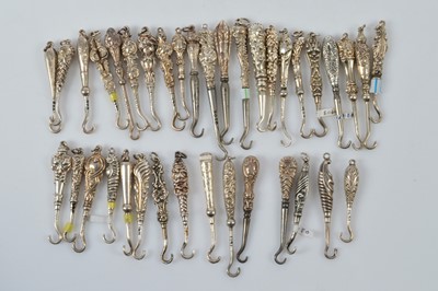 Lot 585 - A collection of small silver handled button or glove hooks