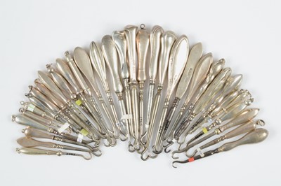 Lot 587 - A collection of silver handled small button hooks