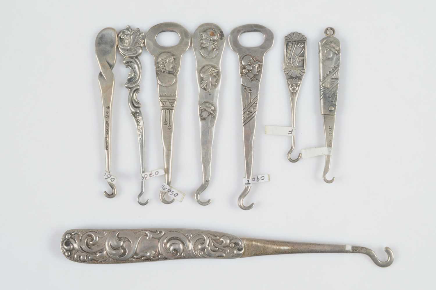 Lot 588 - Eight Sterling marked button hooks