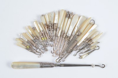 Lot 590 - A collection of mother of pearl handled button hooks