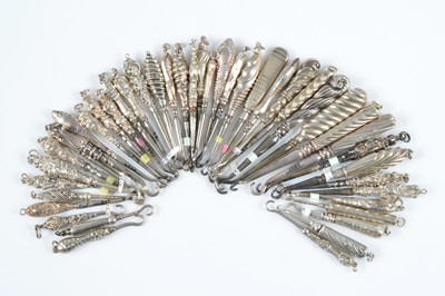 Lot 594 - A collection of silver handled button hooks