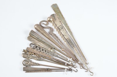 Lot 597 - Fourteen sterling marked button hooks