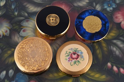 Lot 642 - Four circular 1950s gilt metal powder compacts