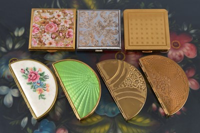Lot 643 - Four 1950s demi lune gilt metal compacts
